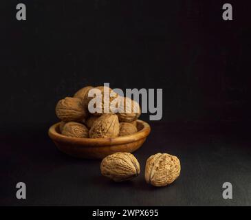 Inshell walnuts in a plate. Heart Nuts, Heart Health Products, Structured Walnuts . Healthy food protein. Fresh raw walnuts full of healthy fats, fibe Stock Photo