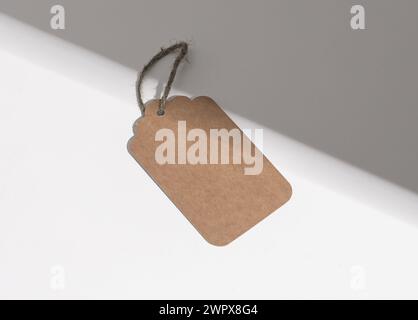 Kraft paper tag, carton label, sale blank card on rope, twine. Stock Photo