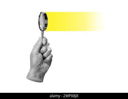 Magnifying glass in hand, searching, researching, focusing on yellow light. Insight, solution, find and study concept Stock Photo