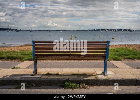 Poole, Dorset, England, UK - September 28, 2022: A bench overlooking Parkstone Bay Stock Photo