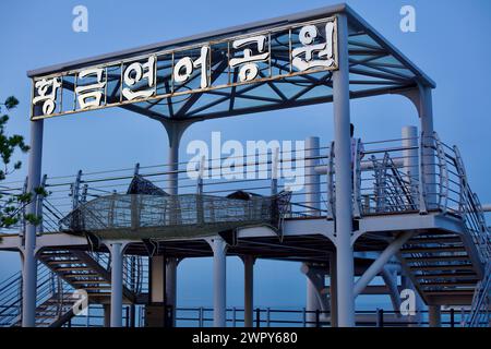 Yangyang County, South Korea - July 30, 2019: The open-air Golden Salmon Park lookout platform at the north end of Jeongam Beach, featuring stairs lea Stock Photo