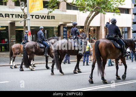 Mounted police monitor demonstrators during a Sydney march supporting Palestinians in the Gaza War. Stock Photo