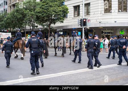Police monitor demonstrators during a Sydney march supporting Palestinians in the Gaza War. Stock Photo