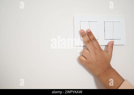 child finger turning on lighting switch with copyspace  Stock Photo
