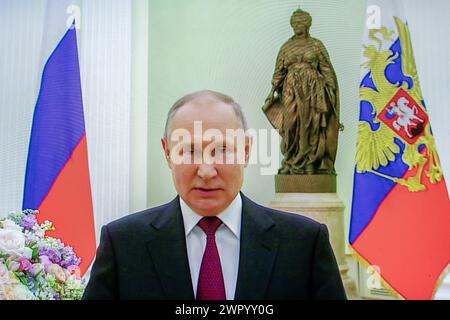 Russia. 08th Mar, 2024. A picture taken of a screen shows Russian President Vladimir Putin congratulating Russian women on International Women's Day on March 8 via video conference in the Kremlin. Credit: SOPA Images Limited/Alamy Live News Stock Photo