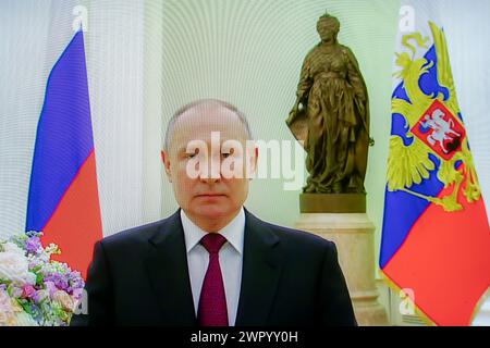 Russia. 08th Mar, 2024. A picture taken of a screen shows Russian President Vladimir Putin congratulating Russian women on International Women's Day on March 8 via video conference in the Kremlin. Credit: SOPA Images Limited/Alamy Live News Stock Photo