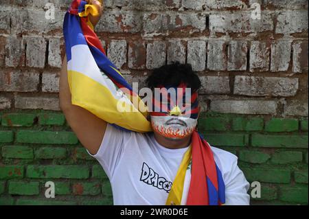 Delhi, New Delhi, India. 10th Mar, 2024. A Tibetan men face is painted in the colours of the Tibetan flags during a protest in New Delhi, India on 10 March, 2024 (Credit Image: © Deep Nair/ZUMA Press Wire) EDITORIAL USAGE ONLY! Not for Commercial USAGE! Stock Photo