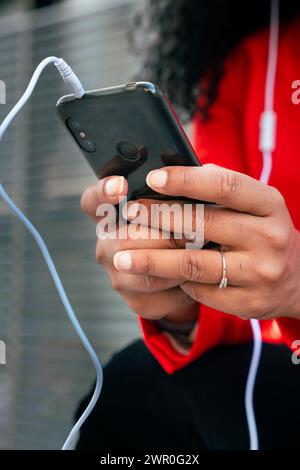 Vertical portrait unrecognizable business woman sitting browsing the internet on a smartphone  Stock Photo