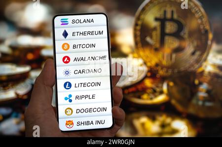 Cryptocurrencies logos like bitcoin and ethereum displayed on smart device Stock Photo