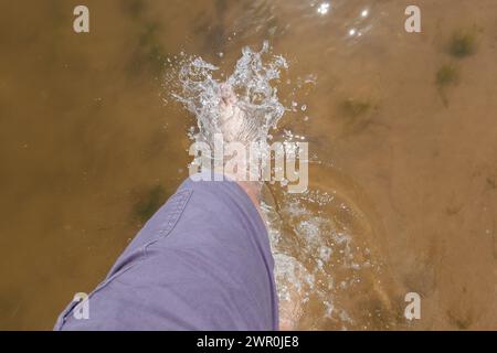 Walking through calm seawater barefooted Stock Photo