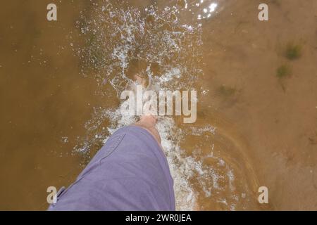 Walking through calm seawater barefooted Stock Photo