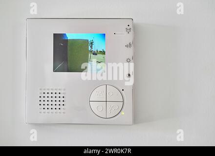 Concept of home automation smart modern luxury wealthy home. On white wall home video intercom with street view talkback or doorphone voice communicat Stock Photo