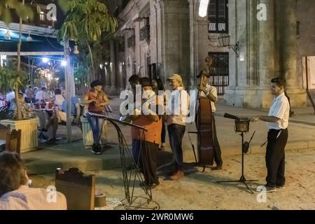 Cuban orchestra plays in front of the restaurant at night in Old Havana Stock Photo