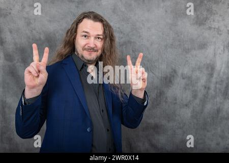 Professional man with long hair in elegant blue suit posing in different confident stances Stock Photo