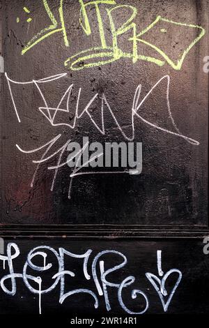 Chinatown, London UK, March 08 2024, Hand Written Graffiti On A Black Painted Door with No People Stock Photo
