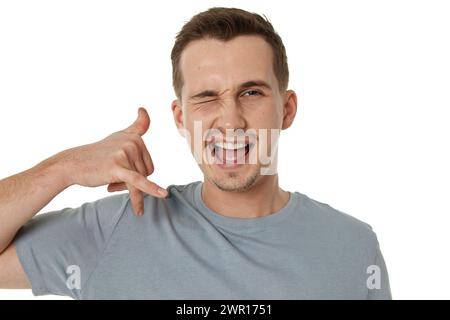 young smiling man showing phone gesture on white background. call me Stock Photo