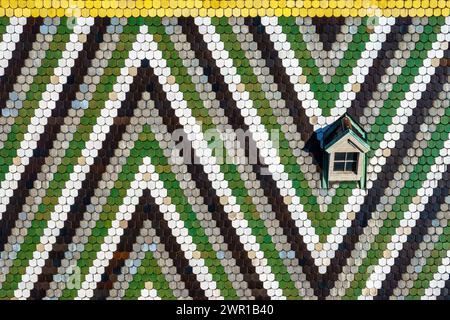 St. Stephen's Cathedral in Vienna, Austria. Detail view of colorful glazed tiles and window on the Stephansdom roof. Zigzag pattern of the roof. Stock Photo