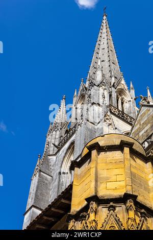 The top of the tower of Sainte-Marie Cathedral illuminated by the sun against the backdrop of the blue sky. Bayonne, Pyrénées-Atlantiques, France. Stock Photo