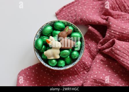 Chocolate candies and daffodils. Springtime holidays concept. Stock Photo