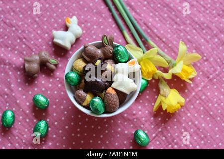 Milk chocolate bunny and eggs on a table. Bright and colorful Easter card. Stock Photo