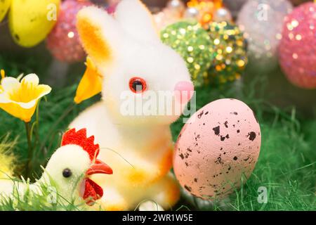 Easter bunny with hen and eggs. Happy Easter decor. Springtime holidays. Easter toys and painted eggs. Traditional spring symbols. Stock Photo