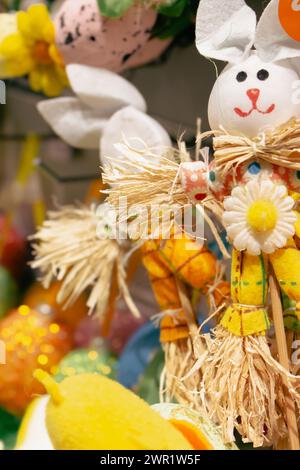 Easter bunny with flower decor. Happy Easter design. Springtime holidays. Handmade Easter toys. Traditional spring symbols. Stock Photo