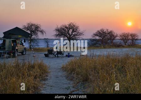 A camp sight set up for the night next to salt pans in the Botswana bush Stock Photo