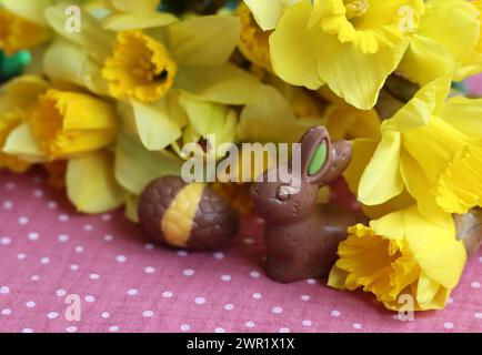 Milk chocolate bunny and eggs on a table. Bright and colorful Easter card. Stock Photo
