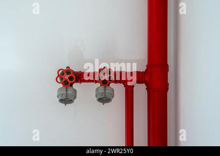 Red fire hydrant pipes and valves in a building Stock Photo