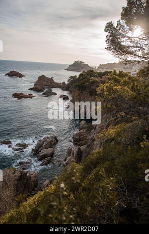 Rugged cliffs along Costa Brava looking towards the Muralles de Tossa de Mar Stock Photo