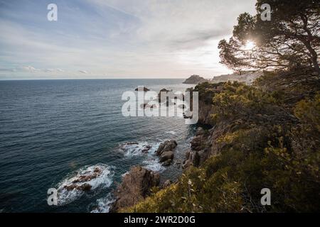 Rugged cliffs along Costa Brava looking towards the Muralles de Tossa de Mar Stock Photo