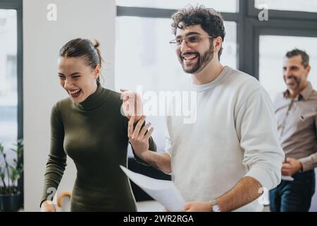 A diverse team of business people analyzing statistics and discussing ideas for business growth in a corporate office and positive working atmosphere. Stock Photo