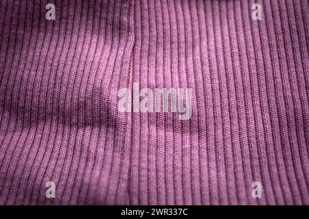 Close-up of purple knit with seam, ribbed, distinct texture, curved fabric. Stock Photo