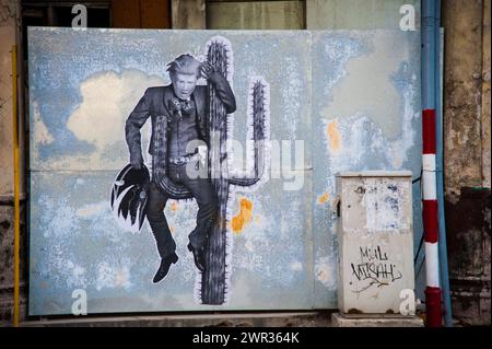 Street mural artwork of Donald Trump as a cowboy sitting on a thorny cactus  in Havana, Cuba Stock Photo