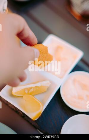 Delicious fried shrimps elegantly served with sauces on the restaurant table, Portugal Stock Photo