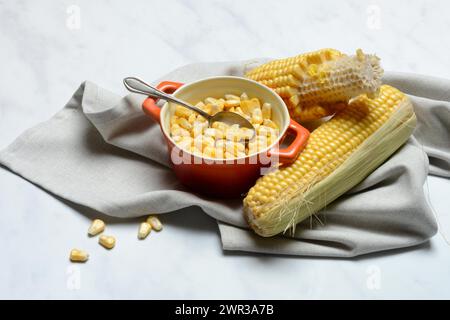 Fresh maize kernels in pots and cobs, corn (Zea mays) Stock Photo