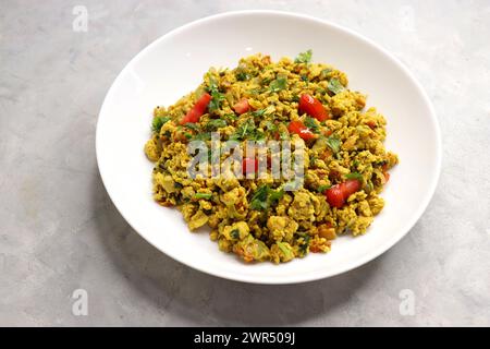 Anda Masala Bhurji or Spicy Indian scrambled eggs with bread or Bun Pav, a popular street food in Mumbai. Served in white plate along with copy space Stock Photo