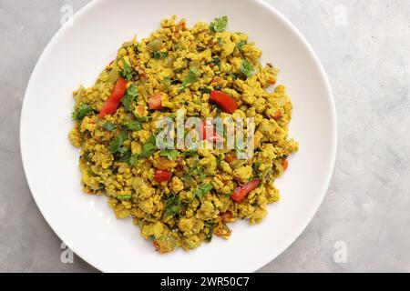 Anda Masala Bhurji or Spicy Indian scrambled eggs with bread or Bun Pav, a popular street food in Mumbai. Served in white plate along with copy space Stock Photo