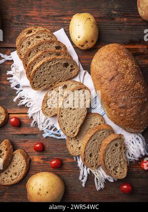 Top view of freshly baked rustic bread. Bread slices concept Stock Photo