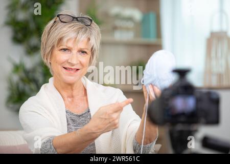 mature woman speaking to the camera about knitting Stock Photo