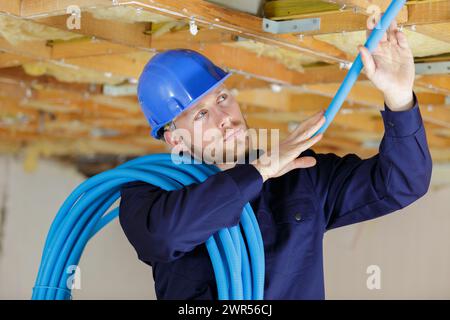 electrician working with wires in construction site Stock Photo