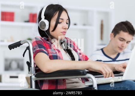 student in wheelchair working with a classmate Stock Photo