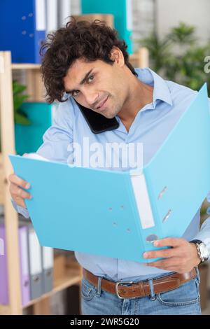 businessman holding document and speaking on phone Stock Photo
