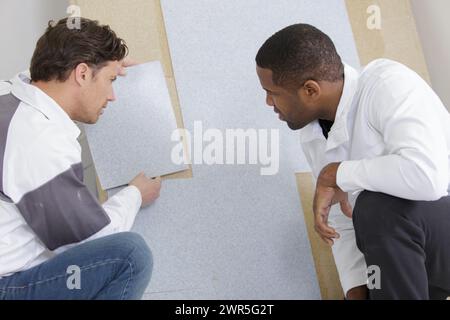two workers checking something on the wall Stock Photo