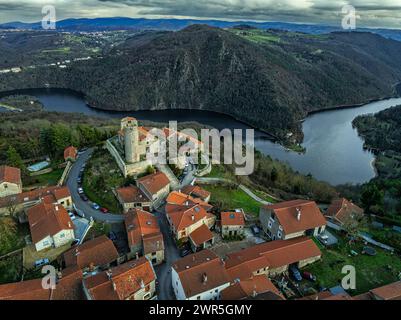 Aerial view of the small medieval town of Chambles with the tower and the stone church. In the background the Gorges de la Loire. France Stock Photo