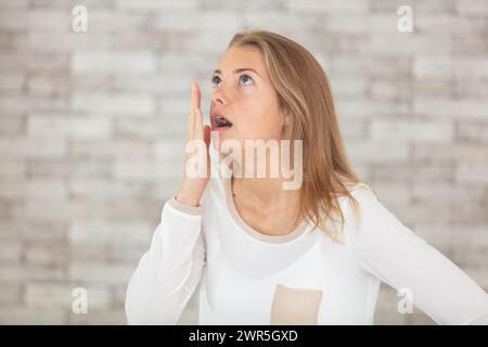 young bored woman yawning at home Stock Photo