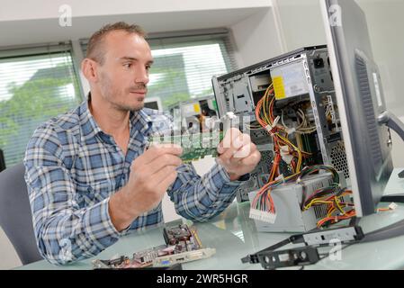 a man is fixing computer Stock Photo