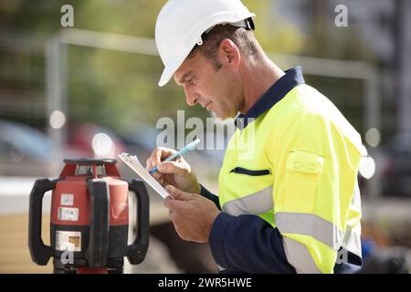 surveyor making notes on site Stock Photo