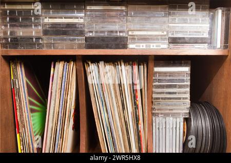 Vinyl disc, compact discs and cassettes on old furniture. Retro. Stock Photo