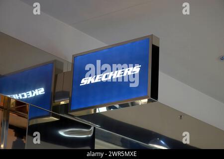 Logo of Skechers on the shop at Shopping Mall. Skechers is an American shoes company. Stock Photo